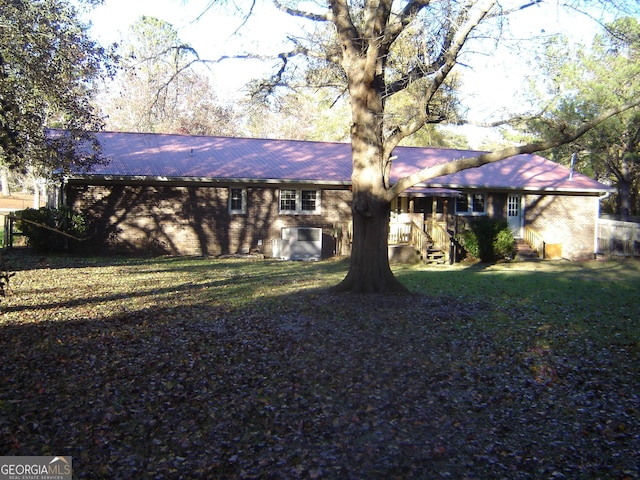 rear view of house with a lawn