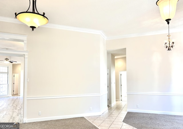 spare room with ceiling fan, light tile patterned floors, and ornamental molding