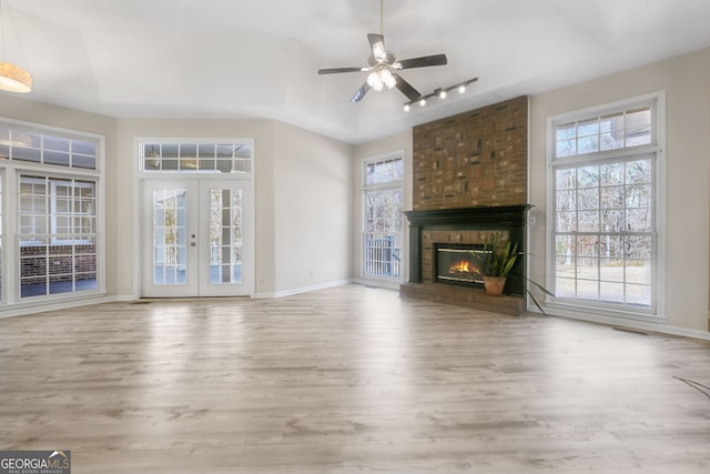 unfurnished living room with plenty of natural light and light hardwood / wood-style floors