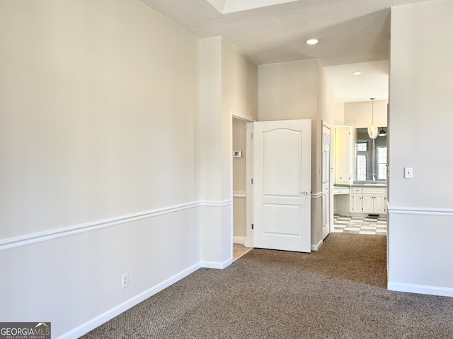 carpeted spare room featuring sink