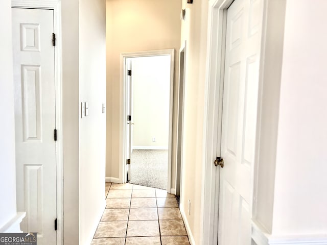 hall with light tile patterned floors