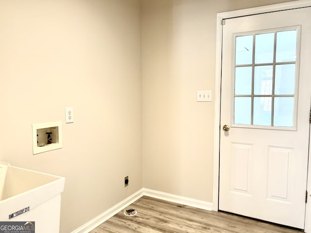 washroom with washer hookup, light hardwood / wood-style floors, electric dryer hookup, and sink