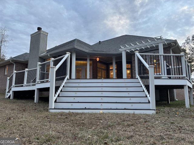 back of house featuring a pergola and a deck