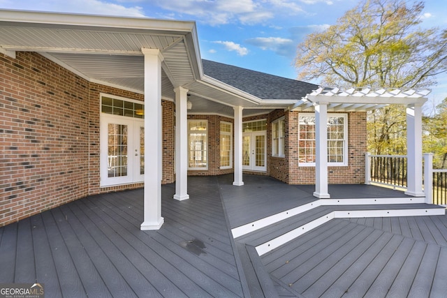 deck featuring a pergola and french doors