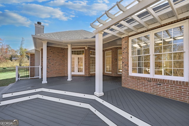 deck featuring a pergola and french doors