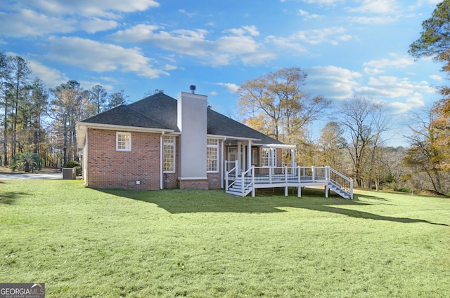 back of house with a wooden deck and a yard