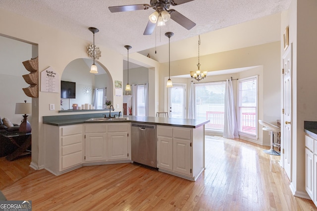 kitchen with white cabinets, light wood-type flooring, stainless steel dishwasher, and sink