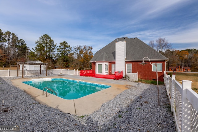 view of swimming pool featuring a deck and a patio