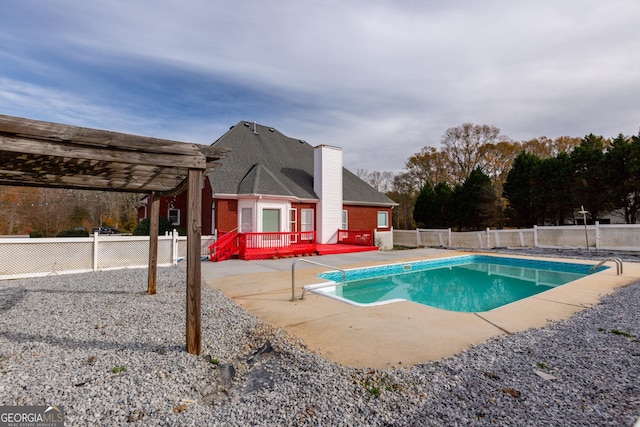 view of swimming pool featuring a patio area, a pergola, and a wooden deck