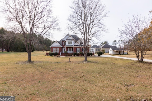 cape cod-style house featuring a front yard and covered porch