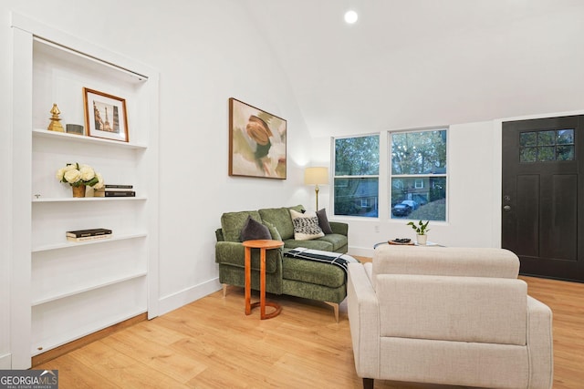 living area with hardwood / wood-style floors and lofted ceiling