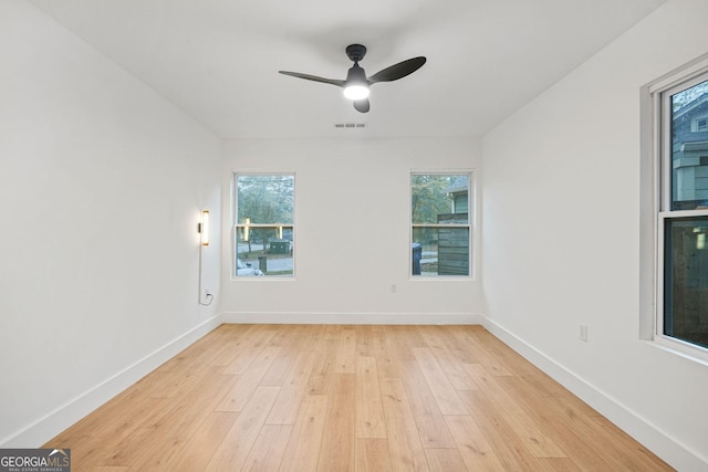 unfurnished room with ceiling fan and light wood-type flooring