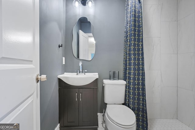 bathroom featuring toilet, vanity, and walk in shower