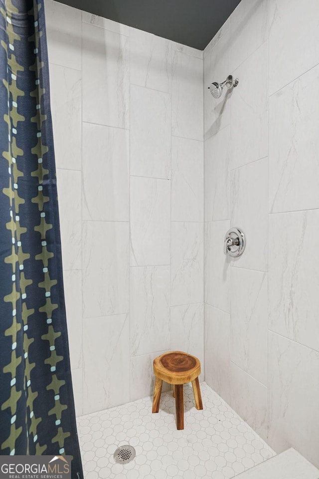 bathroom with a tile shower