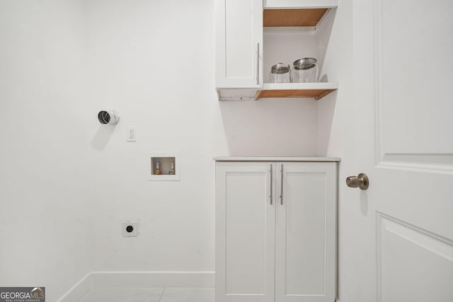 clothes washing area featuring hookup for an electric dryer, hookup for a washing machine, and light tile patterned floors