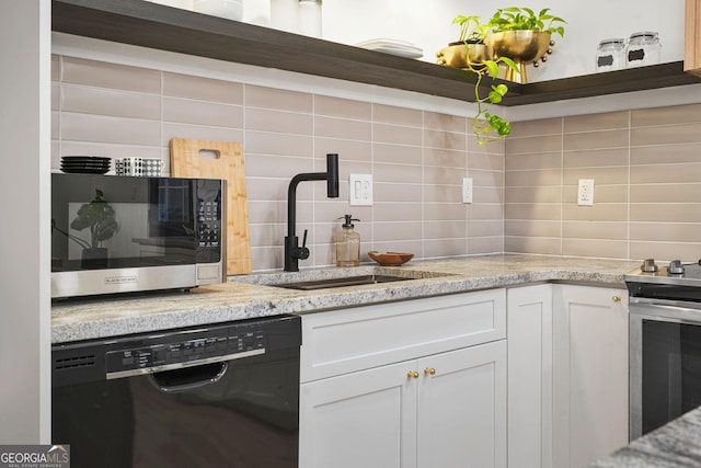 kitchen featuring tasteful backsplash, white cabinets, and appliances with stainless steel finishes