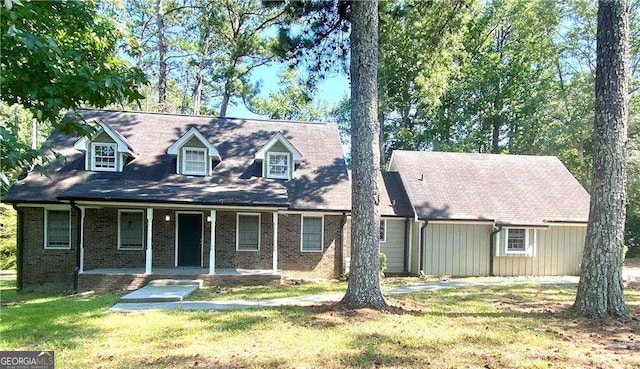 cape cod home with a porch and a front yard