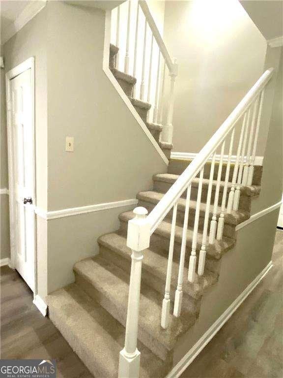 stairs featuring hardwood / wood-style flooring