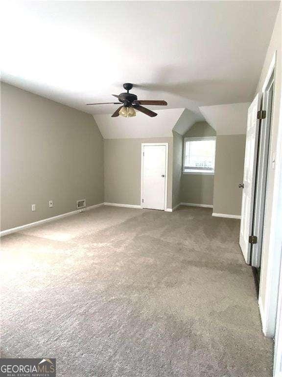 bonus room featuring carpet, ceiling fan, and vaulted ceiling