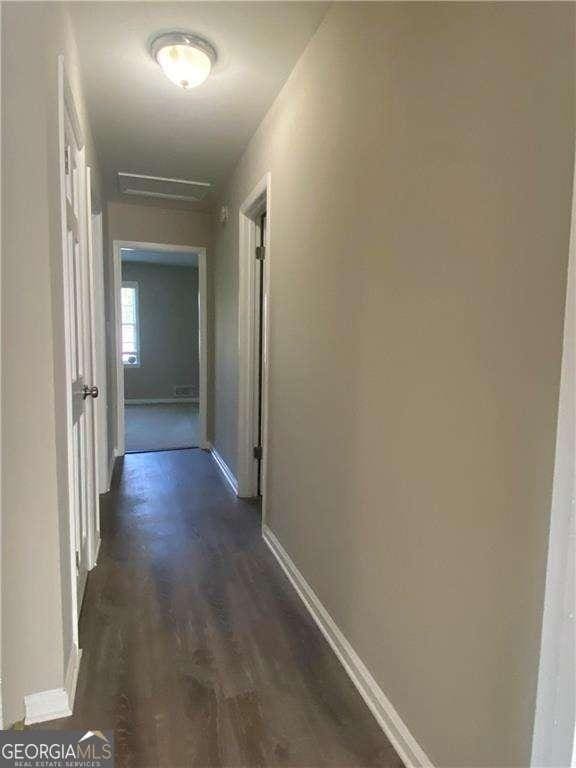 hallway with dark hardwood / wood-style floors