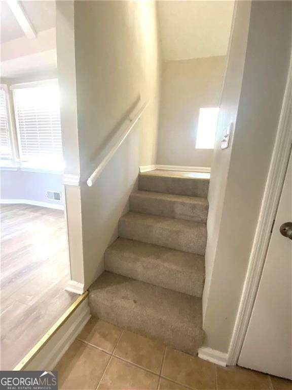 staircase with tile patterned flooring