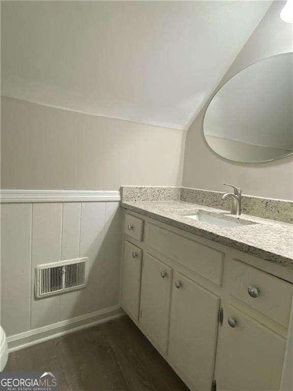 bathroom featuring hardwood / wood-style flooring and vanity