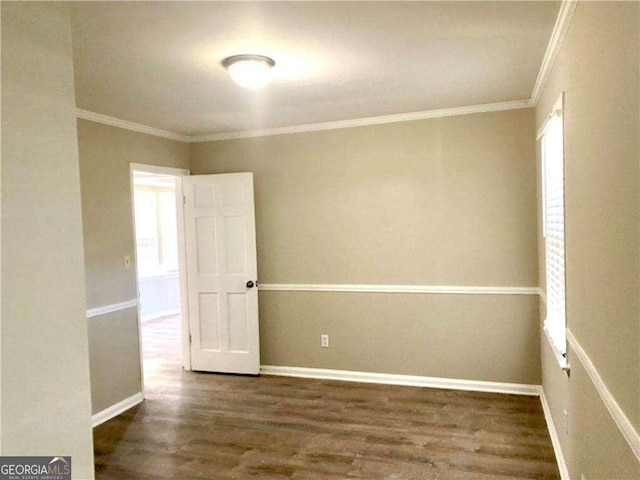 unfurnished room featuring dark hardwood / wood-style flooring and ornamental molding