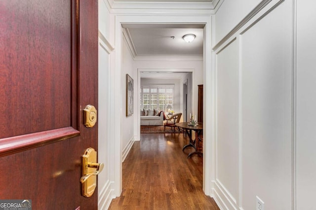 hall featuring dark wood-type flooring and ornamental molding