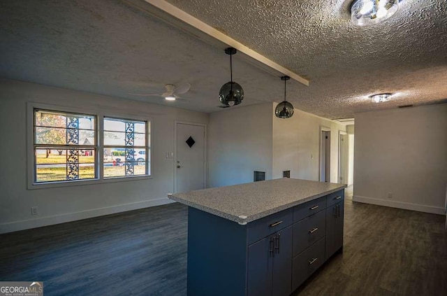 kitchen with dark wood-type flooring, ceiling fan, a textured ceiling, decorative light fixtures, and a kitchen island