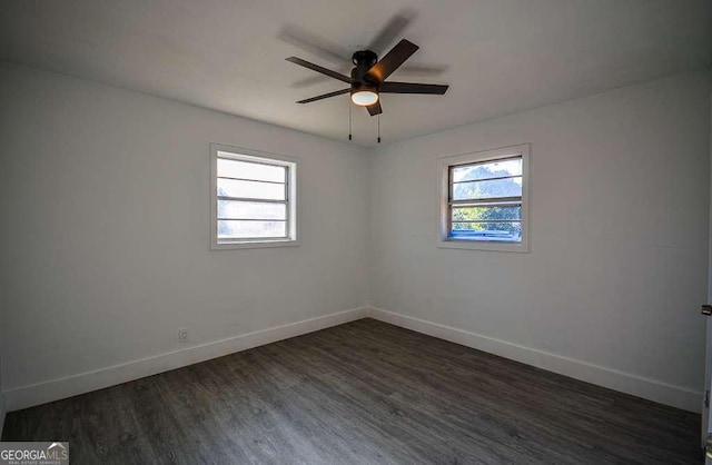 unfurnished room featuring dark hardwood / wood-style floors and ceiling fan