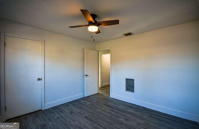 unfurnished bedroom with dark hardwood / wood-style floors and ceiling fan