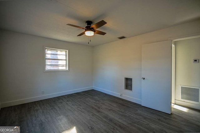 empty room featuring ceiling fan and dark hardwood / wood-style flooring