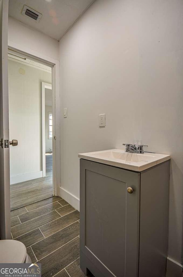 bathroom with hardwood / wood-style floors and vanity