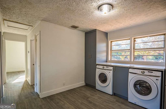 laundry room with separate washer and dryer, dark hardwood / wood-style flooring, and a textured ceiling