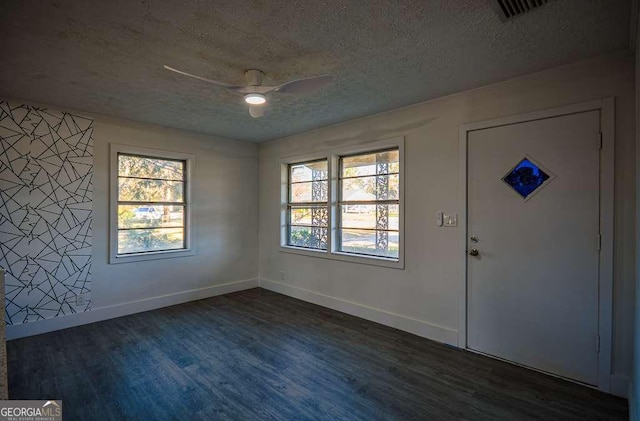 foyer with a textured ceiling, dark hardwood / wood-style flooring, and ceiling fan