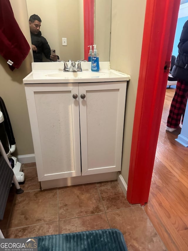 bathroom with hardwood / wood-style floors and vanity