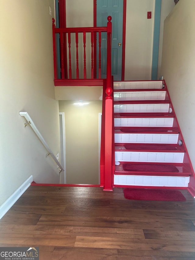 stairway featuring hardwood / wood-style flooring