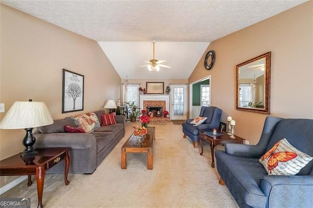 living room with a textured ceiling, a fireplace, and vaulted ceiling