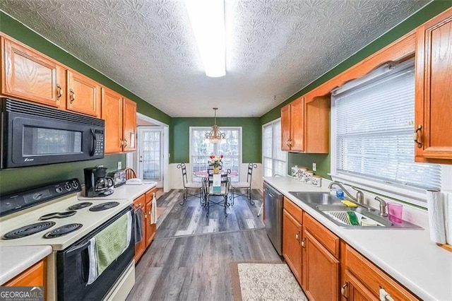 kitchen featuring hanging light fixtures, stainless steel dishwasher, white range with electric stovetop, a textured ceiling, and hardwood / wood-style flooring