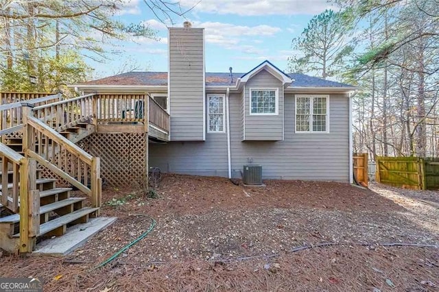 rear view of property featuring a deck and central AC unit