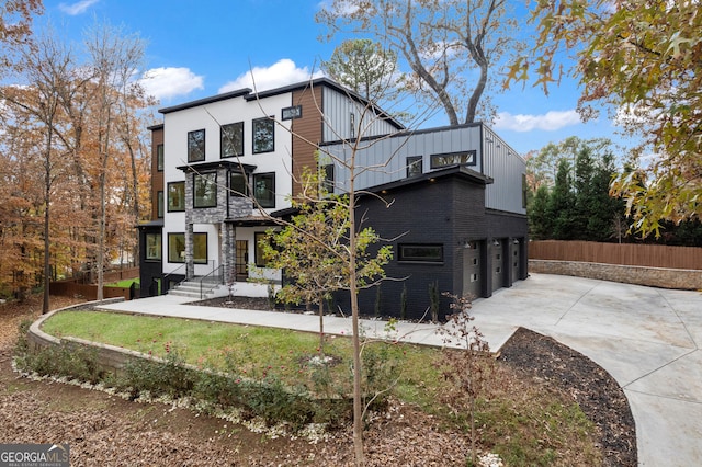 rear view of property featuring a garage