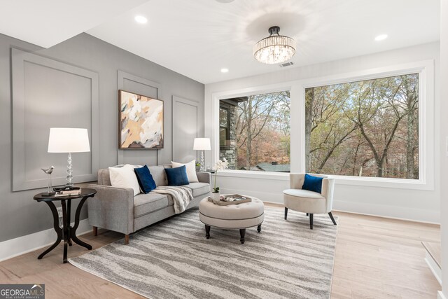 living room featuring light hardwood / wood-style floors and a chandelier