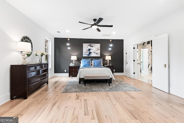 bedroom with ceiling fan and light hardwood / wood-style floors