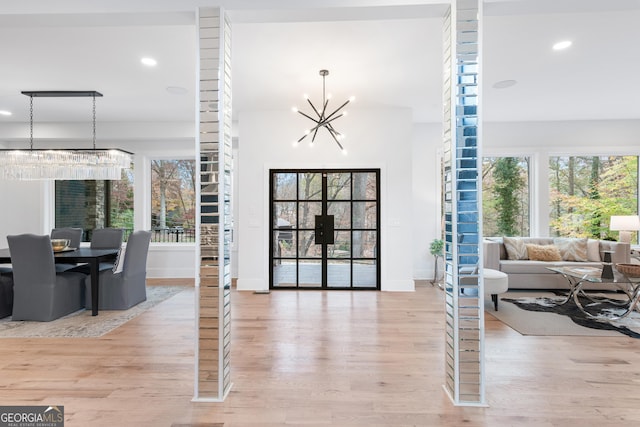 interior space featuring a chandelier and light hardwood / wood-style flooring