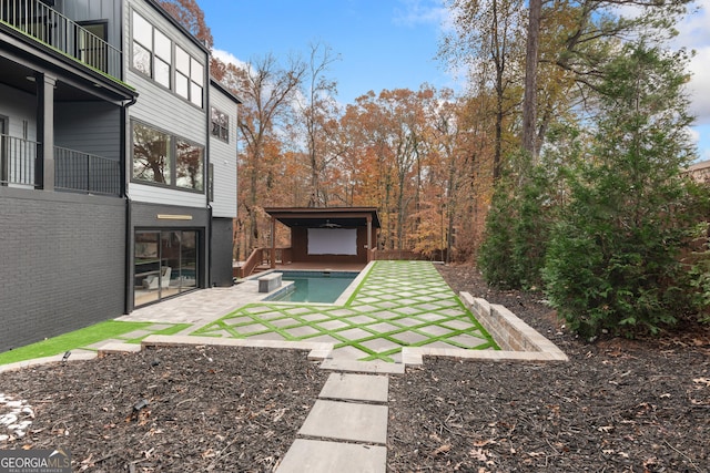 view of yard with a patio area and a balcony