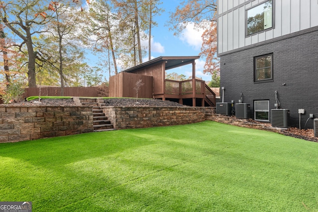 view of yard featuring central AC and a deck