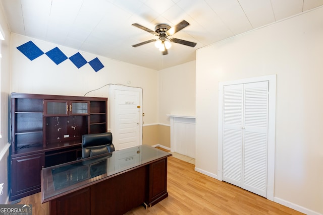 office with ceiling fan and light hardwood / wood-style flooring