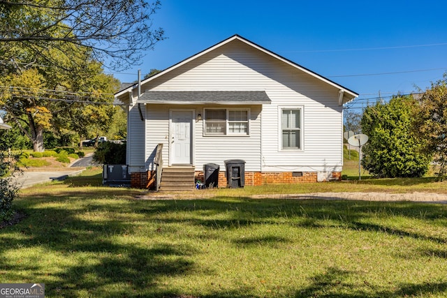 back of property featuring a yard