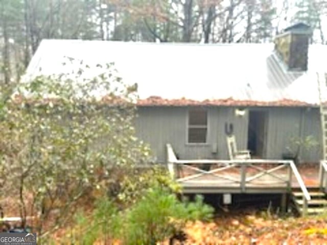 rear view of property with a wooden deck