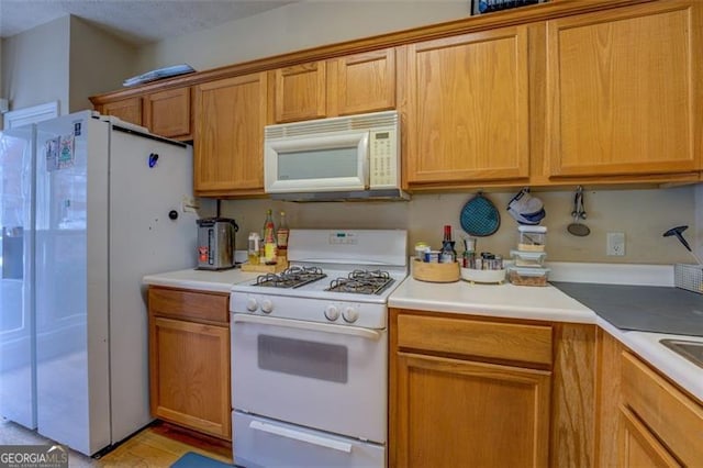 kitchen featuring light hardwood / wood-style floors and white appliances